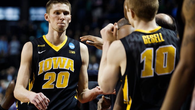 IowaÕs Jarrod Uthoff (20) is welcomed to the bench by his teammates in the final seconds of Iowa's 87-68 loss to Villanova at their second round NCAA Basketball Championship game on Sunday, March 20, 2016 in New York City, New York.