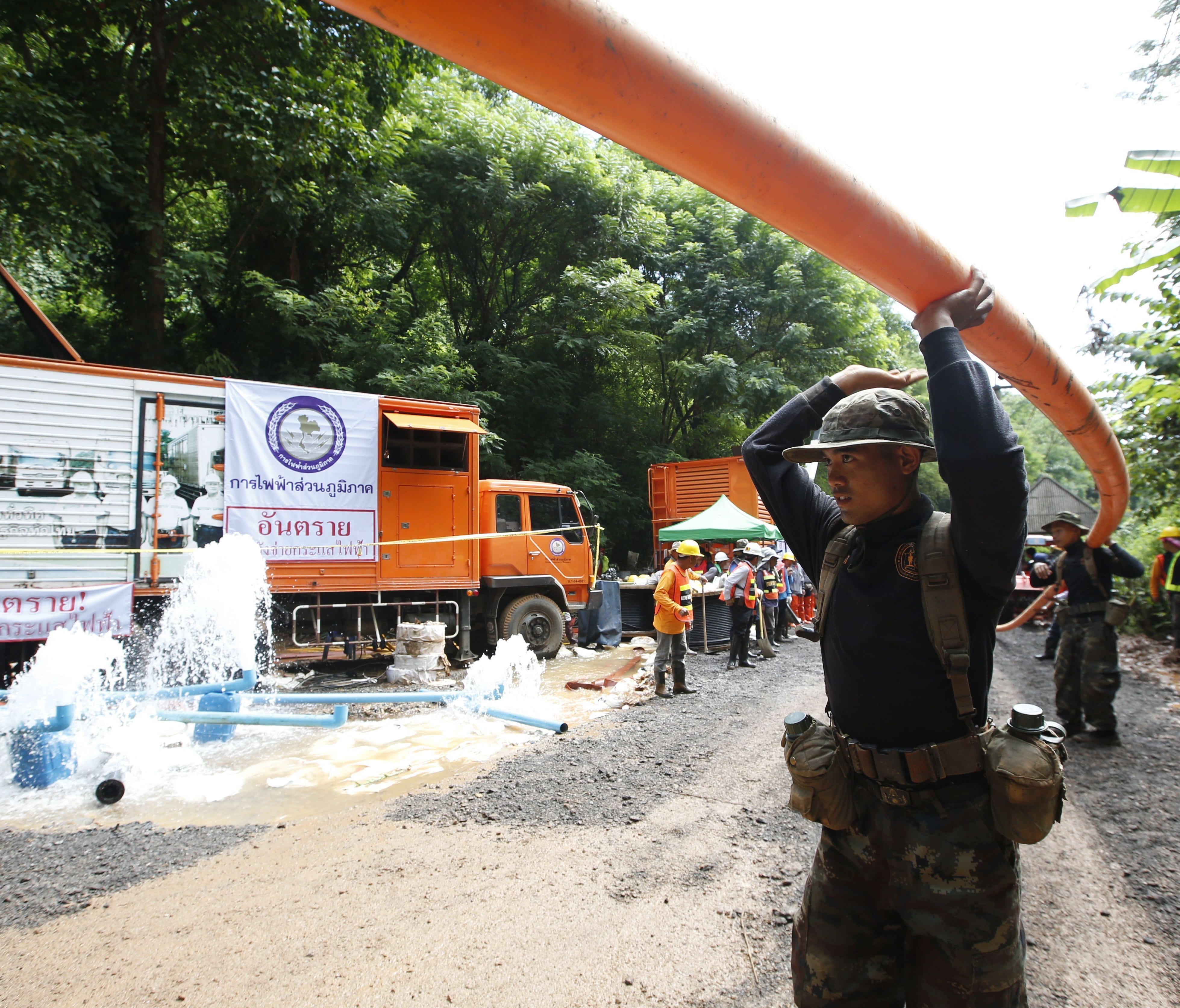 Thai soldiers carry drainpipe while heading to the cave during the ongoing rescue operations for the child soccer team and their assistant coach, at Tham Luang cave in Khun Nam Nang Non Forest Park, Chiang Rai province, Thailand, July 4, 2018.