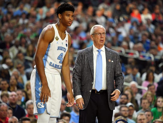 North Carolina coach Roy Williams talks with forward