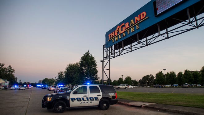 A Lafayette Police Department vehicle blocks an entrance at the Grand Theatre in Lafayette, La., following a shooting Thursday night. At least two people, including the gunman are dead.