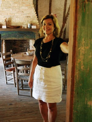 Melanie Lee-Lebouef, Opelousas Tourism director, stands in the doorway of the Venus House at Le Vieux Village.
