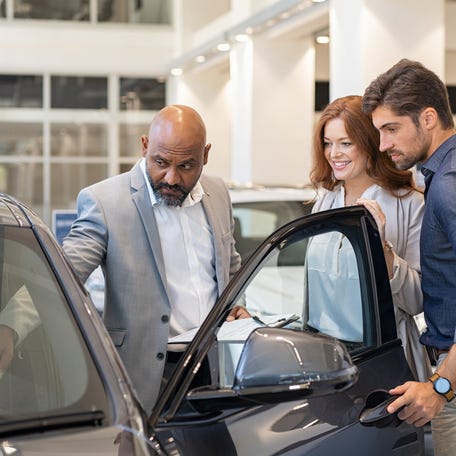Shoppers pick out a new car.