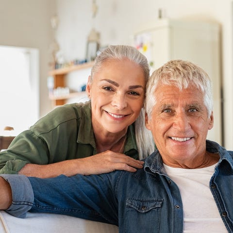 A smiling older couple in their home
