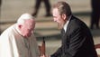 Pope John Paul II shakes hands with Cuban President
