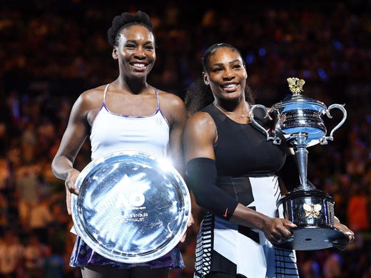 Serena Williams (right) poses with her trophy after