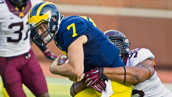 Michigan QB Shane Morris is tackled by Minnesota's Steven Richardson during Saturday's game in Ann Arbor.