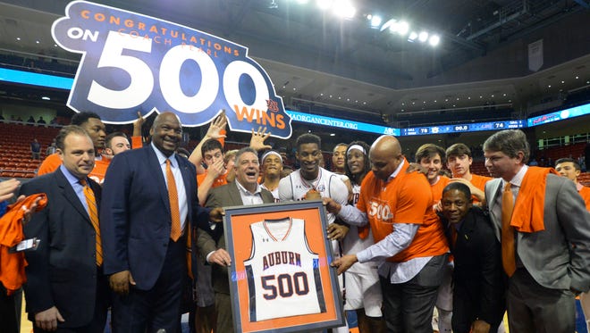 Auburn coach Bruce Pearl, holding plaque, celebrates his 500th career win after the team's victory over LSU in an NCAA college basketball game Wednesday, Jan. 18, 2017, in Auburn, Ala. (Julie Bennett/AL.com via AP)