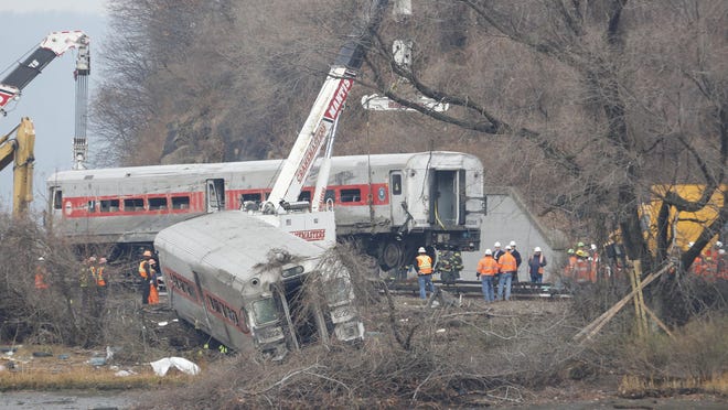 A rail crew works at the scene of the fatal Metro-North train derailment on December 2, 2013 in the Bronx near the Spuyten Duyvil station. The Metro-North passenger train derailed en route to New York City near the Spuyten Duyvil station, killing four people and wounding 63 others on December 1, 2013.