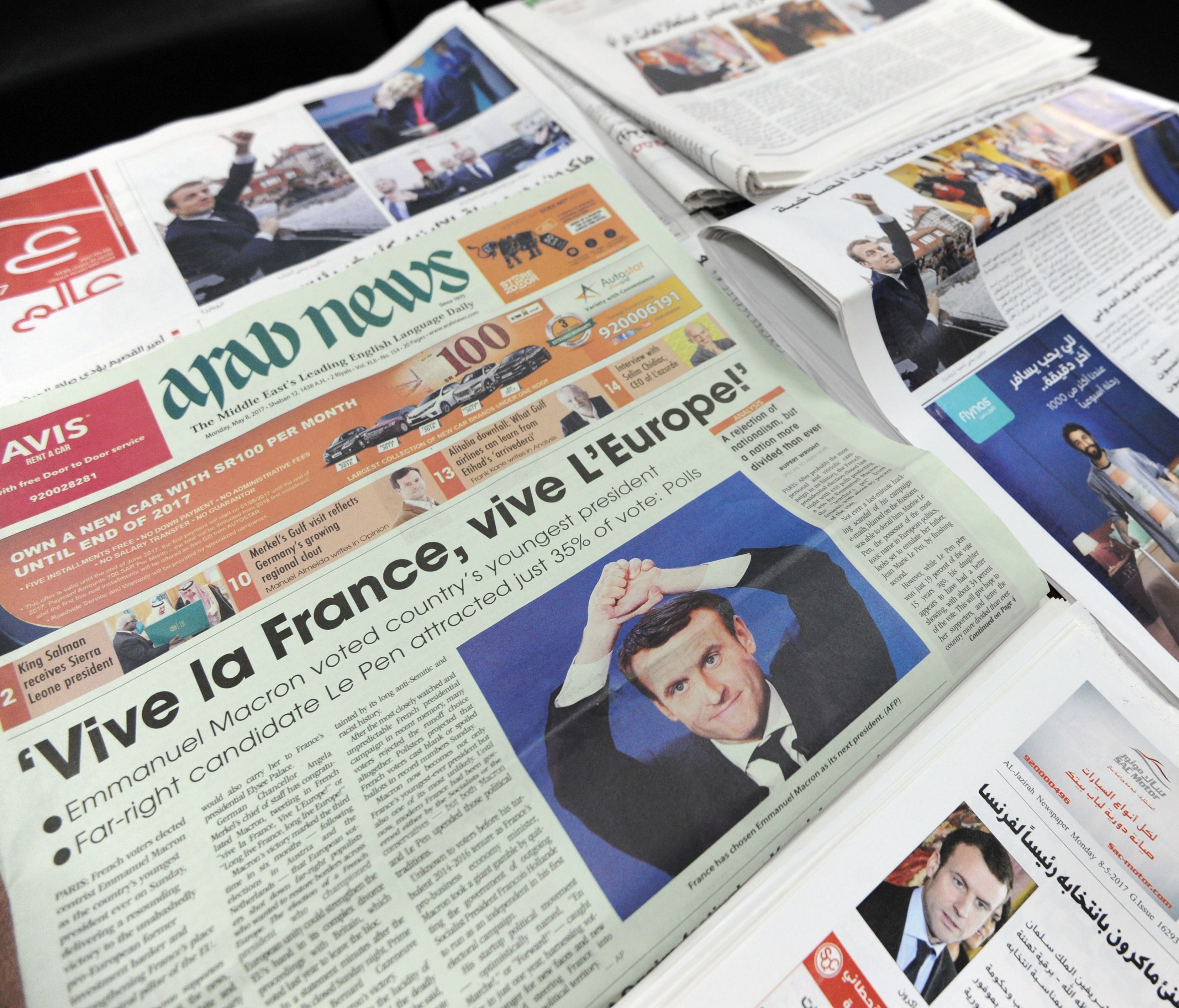 A picture taken on May 8, 2017, shows the front pages of Saudi newspapers reporting on the results of France's presidential election and displaying pictures of French president-elect Emmanuel Macron.