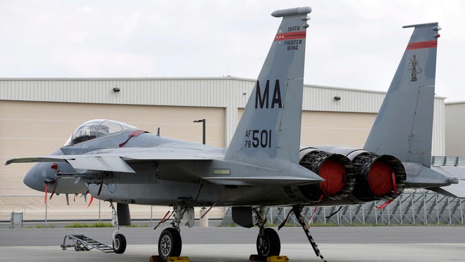 A Massachusetts Air National Guard F-15C fighter aircraft sits near a hangar at Barnes Air National Guard Base, in Westfield, Mass. A 14-year-old Air National Guard proposal could be considered in 2017 that would allow the twin-engine fighters from Massachusetts to fly as low as 500 feet along a corridor in western Maine and the northern tip of New Hampshire.
