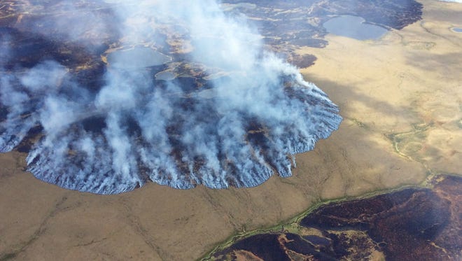 Smoke rises from the Bogus Creek Fire, one of two fires burning in the Yukon Delta National Wildlife Refuge in southwest Alaska  in June 2015. Global warming is carving measurable changes into Alaska, and President Barack Obama is about to see it. President Obama leaves Monday, Aug. 31, 2015 for a three-day visit to the 49th state in which he will speak at a State Department climate change conference and become the first president to visit the Alaska Arctic. More frequent wildfires are believed to be a consequence of climate change in the area.