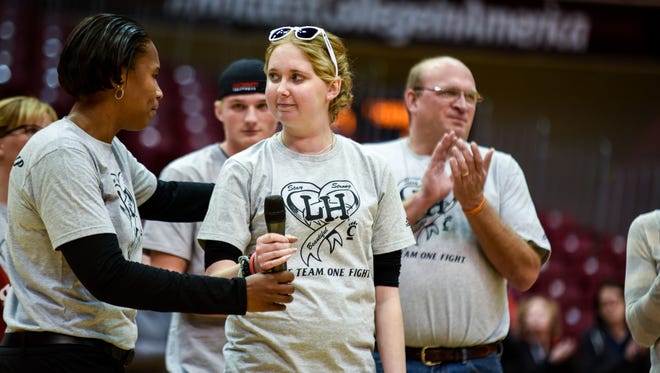 Mount St. Joseph University freshman Lauren Hill prepares to address the crowd at the UC women's basketball game on Friday.