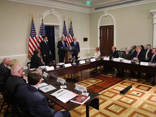 President Trump, flanked by Kansas Secretary of State