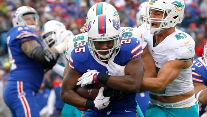 Miami Dolphins middle linebacker Kiko Alonso (47) tackles Buffalo Bills' LeSean McCoy (25) during the first half of an NFL football game, Saturday, Dec. 24, 2016, in Orchard Park, N.Y. (AP Photo/Bill Wippert)