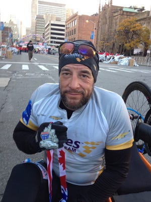 Tom Davis after winning the handcyclist race in the 37th Detroit Free Press Talmer Bank Marathon on Oct. 19, 2014.