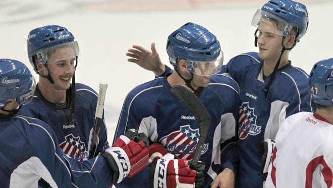 Rochester Americans' Drew Bagnall, center, is congratulated by teammates after he was named team captain.