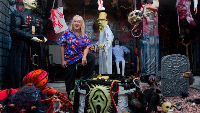 
Debbie Dailey relaxes Wednesday among the hundreds of Halloween decorations that adorn her Fort Myers home.
