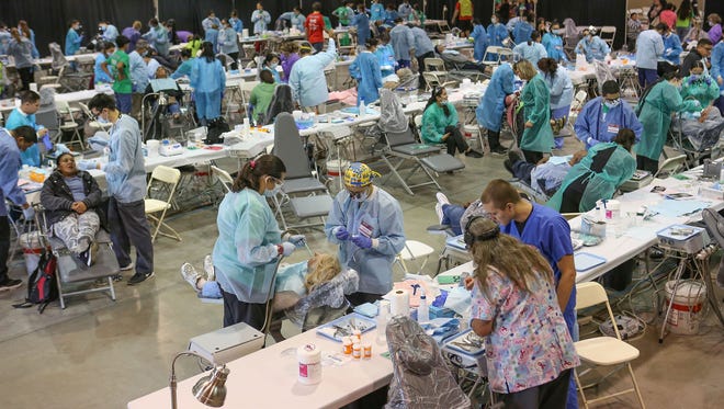 Volunteer dental professionals give dental care to people who need help at the California CareForce clinic at the Riverside County Fairgrounds in Indio, March 31, 2017. 