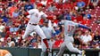 Aug. 22: Reds first baseman Joey Votto, left, tags