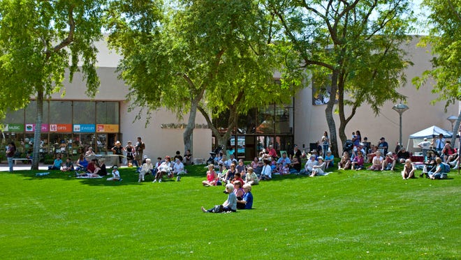 Concertgoers sit on the lawn for a performance at Civic Center Mall in Scottsdale.