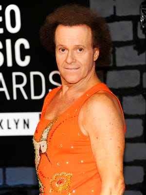 FILE - In this Aug. 25, 2013 file photo, Richard Simmons arrives at the MTV Video Music Awards in the Brooklyn borough of New York. Despite what seems to be a national obsession with the fitness guru’s wellbeing, his publicist, manager, brother and two officers from the LAPD have all said the 68-year-old is at home in the Hollywood Hills and doing fine.