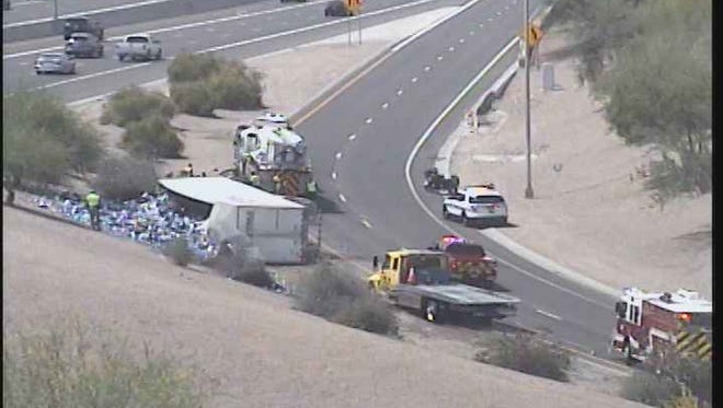 A semitruck carrying a load of Bud Light overturned on the freeway near Tempe on May 7, 2017.