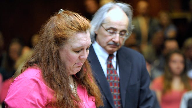 Jennifer Millsap, mother of murder victim April Millsap, keeps her emotions in check as she reads her victim's impact statement as Macomb County's Chief of Homicide Bill Cataldo, right, stands with her..