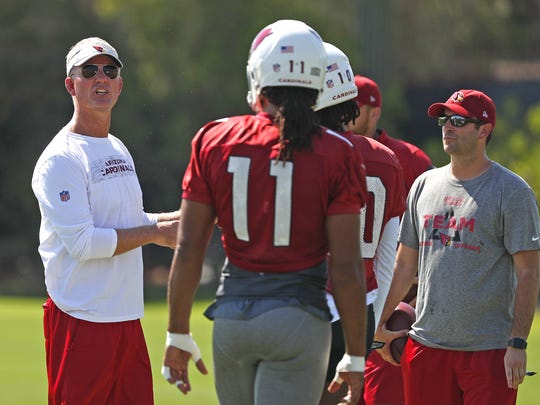 Cardinals offensive coordinator Mike McCoy talks with Larry Fitzgerald during a practice in August.