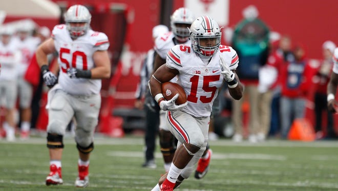 Oct 3, 2015; Bloomington, IN, USA; Ohio State Buckeyes running back Ezekiel Elliott (15) runs with the ball against the Indiana Hoosiers at Memorial Stadium. Ohio State defeats Indiana 34-27. Mandatory Credit: Brian Spurlock-USA TODAY Sports