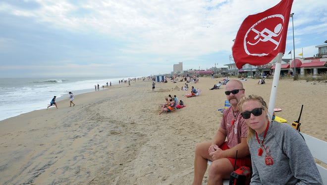 Rehoboth Beach Patrol members Shawn Evans and Alyssa Santangelo watch for beachgoers attempting to swim under red flag conditions at Rehoboth Beach on Monday.