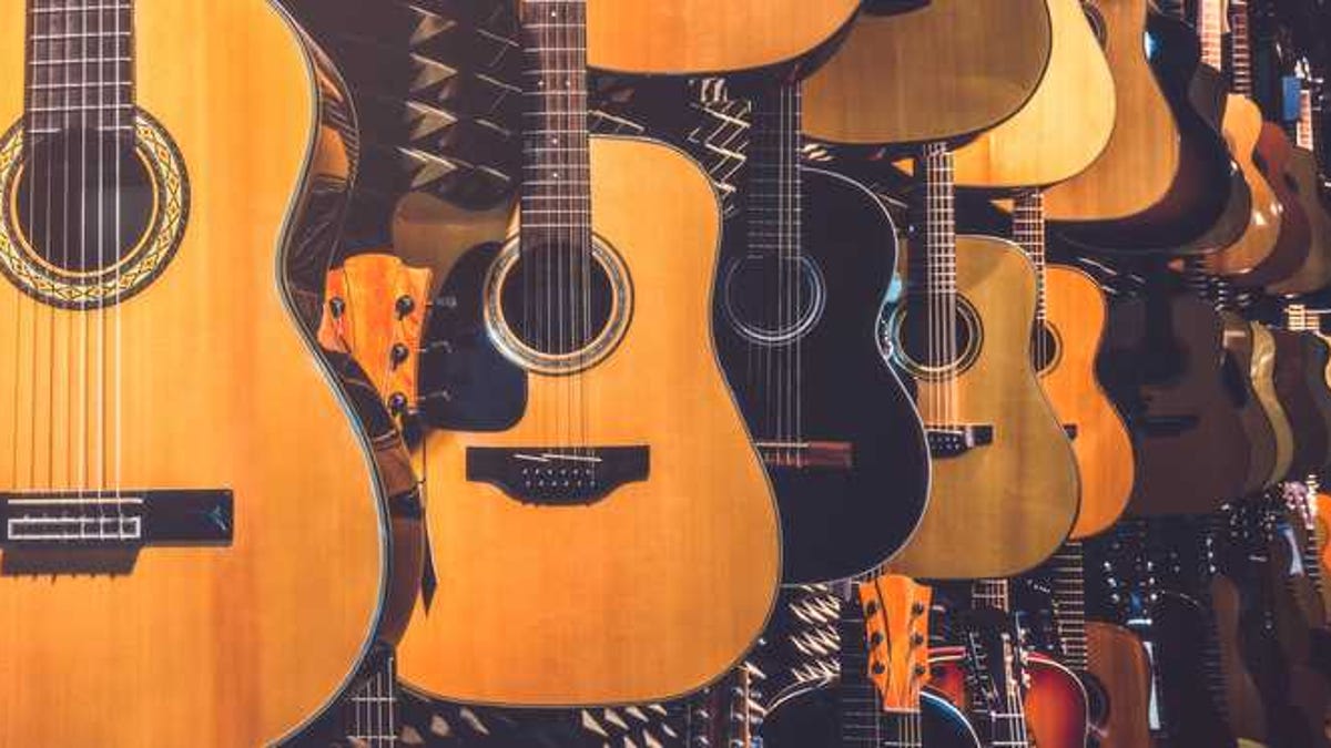 Rows of guitars in a guitar shop.