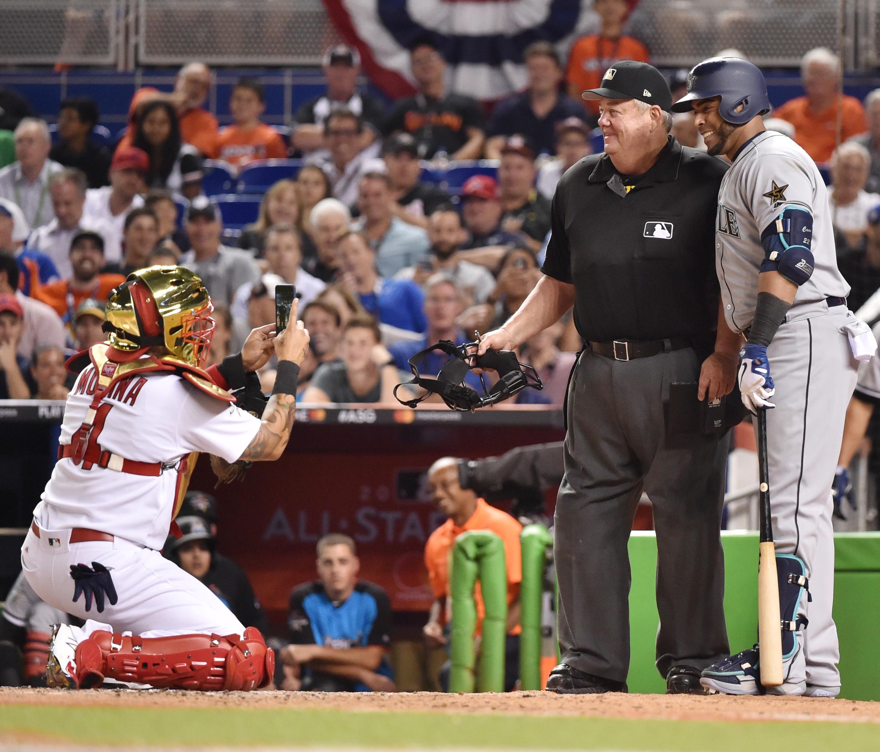 Yadier Molina takes a photo of Nelson Cruz with umpire Joe West in the sixth inning of the All-Star Game.