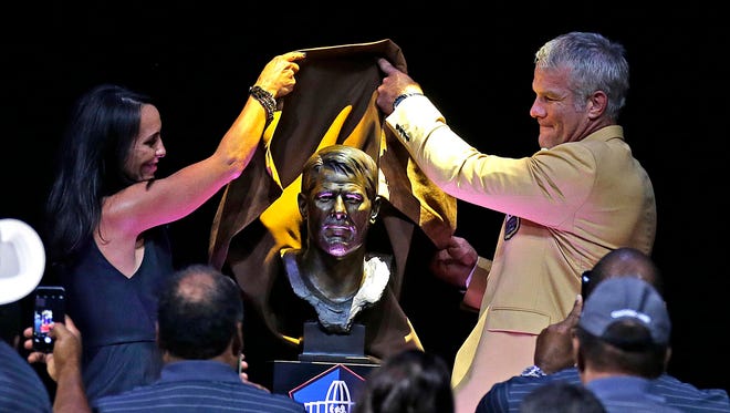 Aug 6, 2016; Canton, OH, USA; Former Green Bay Packers quarterback Brett Favre is introduced by his wife Deanna Favre (left) as his bust is unveiled during the 2016 NFL Hall of Fame enshrinement at Tom Benson Hall of Fame Stadium.