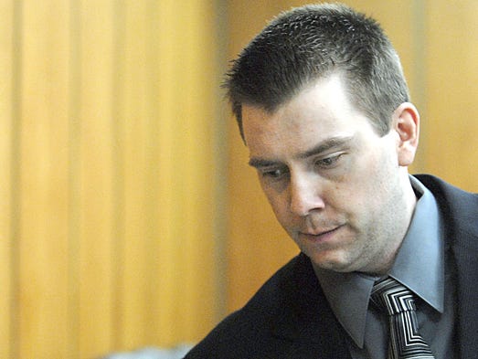 With head lowered, murder defendant James Biela leaves