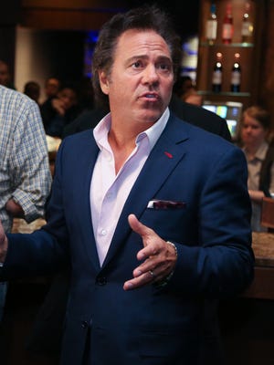Detroit Pistons owner Tom Gores talks with local mentors before a game at the Palace of Auburn Hills on Jan. 18, 2016.
