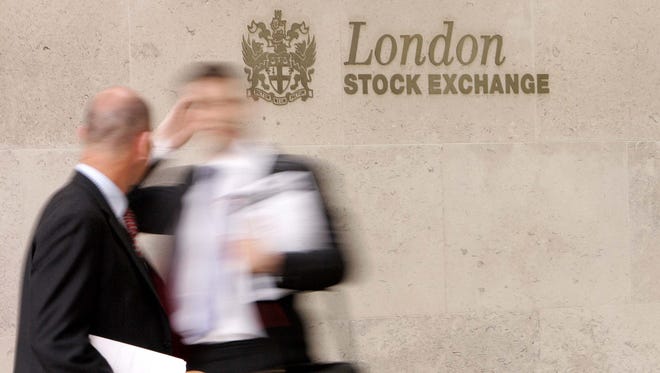 A 2007 file photo shows businessmen outside The London Stock Exchange in central London.