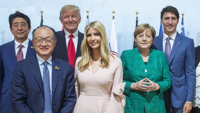Japanese Prime Minister Shinzo Abe, left to right, World Bank President Jim Yong Kim, United States President Donald Trump, his daughter Ivanka Trump, German Chancellor Angela Merkel and Prime Minister Justin Trudeau pose for a photo after the Women and Development event at the G20 summit Saturday, July 8, 2017 in Hamburg, Germany.