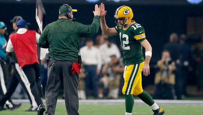Packers quarterback Aaron Rodgers  and head coach Mike McCarthy celebrate a touchdown during first quarter of the divisional playoff game against the Dallas Cowboys.