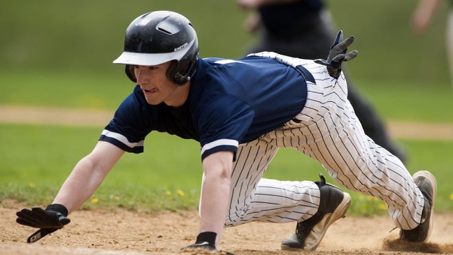 Burlington's Chris Fenimore (11) dives back to first base during the baseball game between BFA-St. Albans and Burlington on Saturday afternoon May 9.