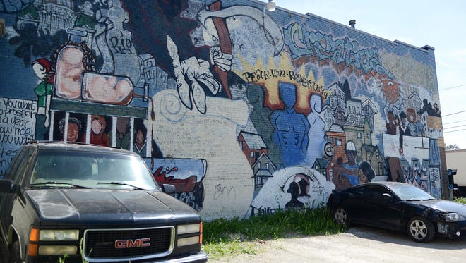 The mural along a wall of Creative Visions in the King Irving neighborhood of Des Moines can be seen Thursday, May 24, 2018. Community organizers hope to revitalize the mural through donations.