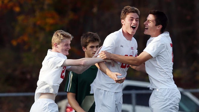 Somers Evan Kieltyka (25) celebrates his first half goal with teammates Jake Faigle (2) and Max Grell (19) against Vestal during the boys soccer regional semifinal  at Lakeland High School in Shrub Oak Nov. 2, 2016. Somers won the game 3-0.