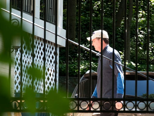Comey walks at his home in McLean, Va., on May 10,