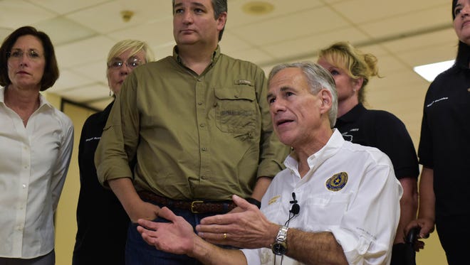 Sen. Ted Cruz (left) and Gov. Greg Abbott speak to the media Monday, Oct. 9, 2017, at the Refugio County Community Center in Refugio. Both visited several Coastal Bend cities to speak with local leaders about hurricane recovery efforts.