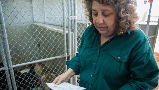 Dr. Beth Vesco-Mock has announced her resignation as executive director of the Animal Service Center of the Mesilla Valley. Monday July 17, 2017. Pictured here Jan. 25, 2017, looks over information on two dogs in one of the shelters kennels.
