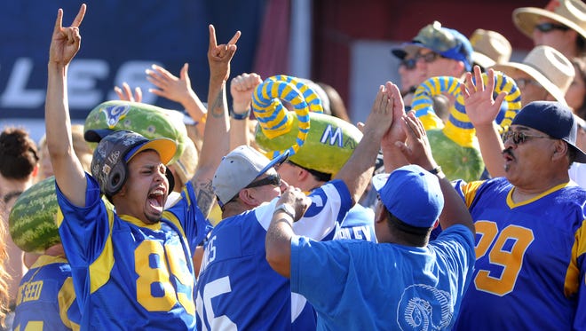 Rams fans react during the game against the Seattle Seahawks as their team seals the victory late in the game Sunday at the Los Angeles Memorial Coliseum.