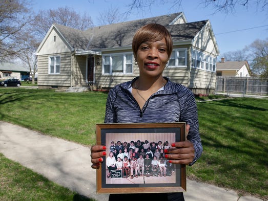 Desiree Brown holds her third-grade class picture at