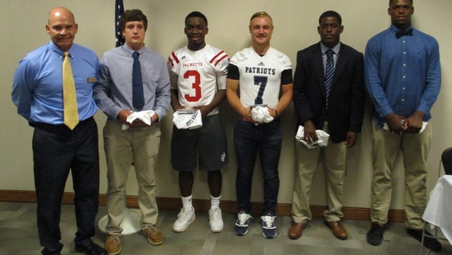 Shown, starting from left is Coach Bruce Ollis, and football players Ben Brown, Daron Williford, Emery Williams, Nick Burton and Zacch Pickens.