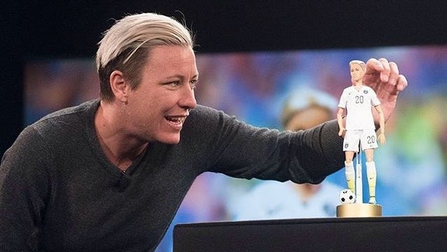 Pittsford native and retired soccer star Abby Wambach looks at her Barbie doll on stage at the Makers Conference on Wednesday in California.