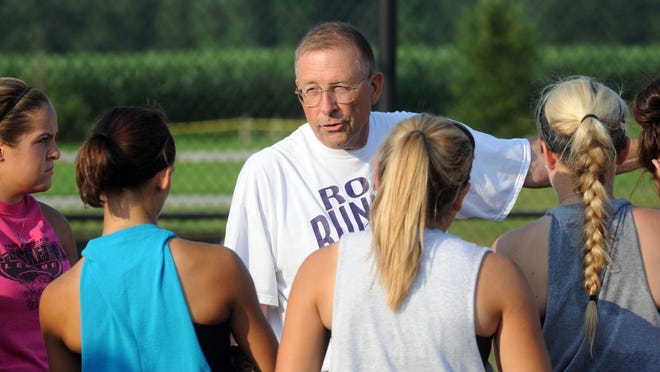 Road Runers Elite coach Rick Sherman talks to members of his team during a 2014 practice at River View High School. Sherman retired after 50 years in coaching recently, marking the end of the Road Runners program, which had existed since 1989.