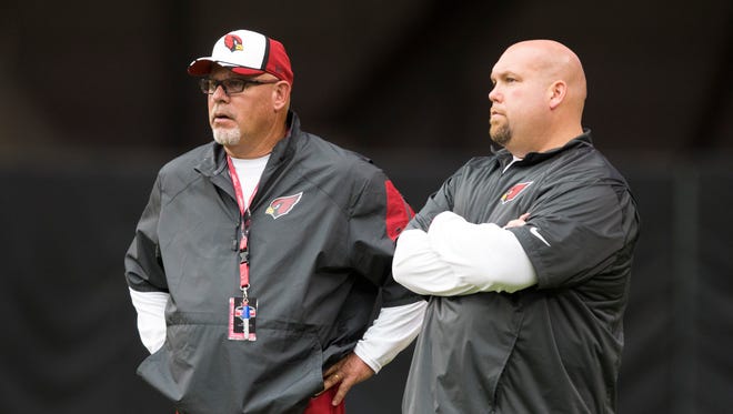 Cardinals head coach Bruce Arians (left) and GM Steve Keim watch training camp at University of Phoenix Stadium in Glendale on July 29, 2014.